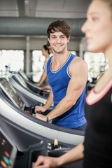 Fototapeta na wymiar Athletic man running on treadmill