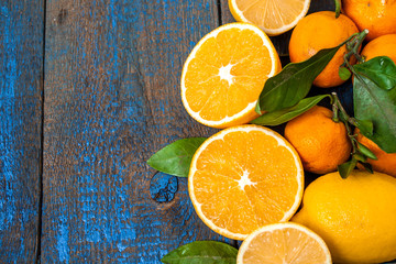 Useful fresh juice, oranges, tangerines, lemons, ice, leaves. view from above. space for text, background
