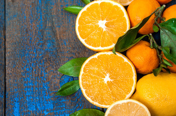 Useful fresh juice, oranges, tangerines, lemons, ice, leaves. view from above. space for text, background