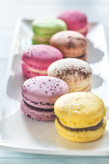 Colorful macarons on the white plate