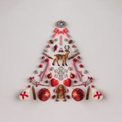 Christmas tree made of Christmas decoration on bright background