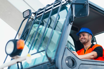 Construction worker operating on Skid Steer Loader © Microgen