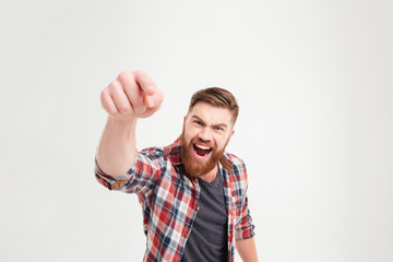 Fototapeta premium Bearded casual man in plaid shirt pointing at camera