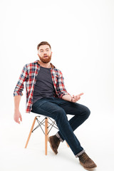 Man talking and gesturing hand while sitting on the chair