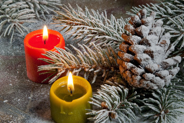 Flaming candles with Christmas twig on the Chritmas table