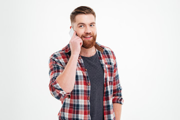 Portrait of a casual bearded man talking on the phone