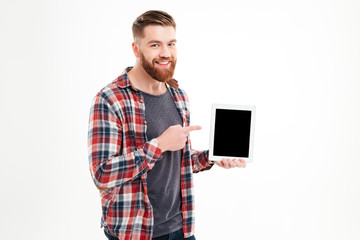 Smiling bearded man pointing finger on blank tablet computer screen