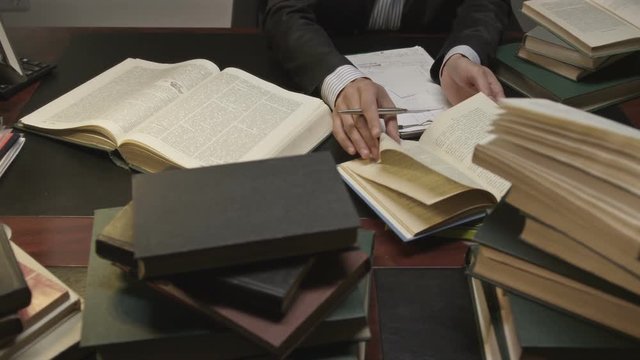 Businessman working and exploring books in the working room. Shot on RED EPIC Cinema Camera.