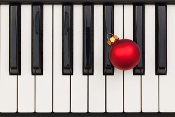 Top view close up shot of piano keyboard and Christmas decoratio