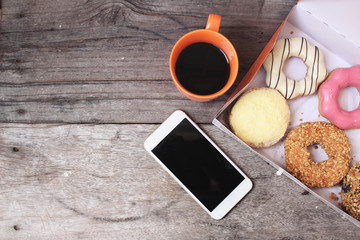 Donuts with espresso coffee and smart phone