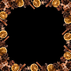 Rustic Christmas frame with orange slices, cinnamon sticks, pine cones, and wood snowflakes