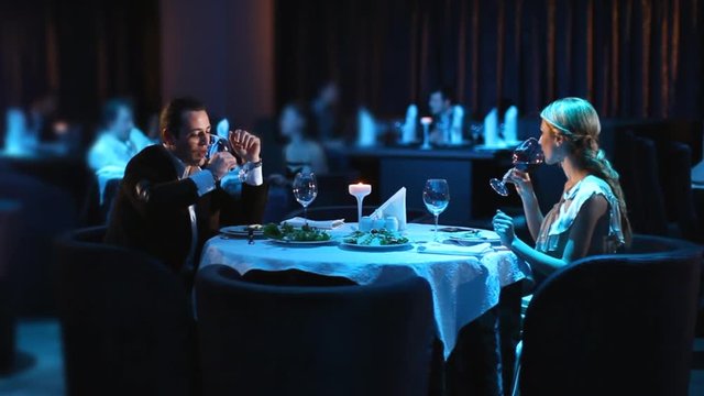 Young couple dining exclusively in a romantic atmosphere in restaurant.