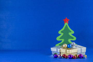 Merry Christmas and Happy New Year concept,Christmas tree with gift box,blue background.