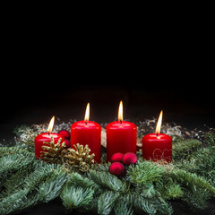 Advent decoration red burning candles christmas tree black