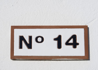 Street sign reading the number fourteen.