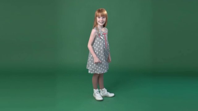 Cute ginger girl ogling and gesturing thumbs up,  chroma key green screen background