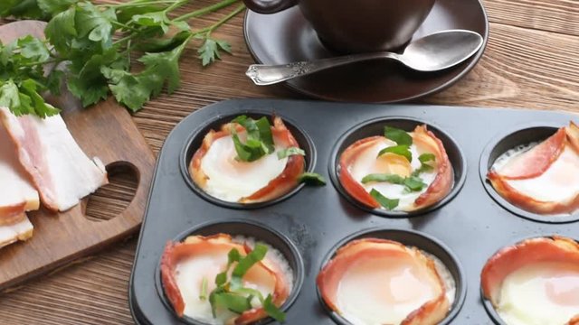 Baked eggs with bacon in muffin tin. Concept of cooking.