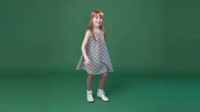 Cute little ginger girl dancing and fooling around, chroma key green screen background