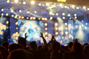 Fototapeta na wymiar Crownd in front of concert stage blurred