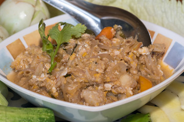 Thai style crab stew in coconut milk with fresh vegetable is one of a delicious Thai food, on wooden background

