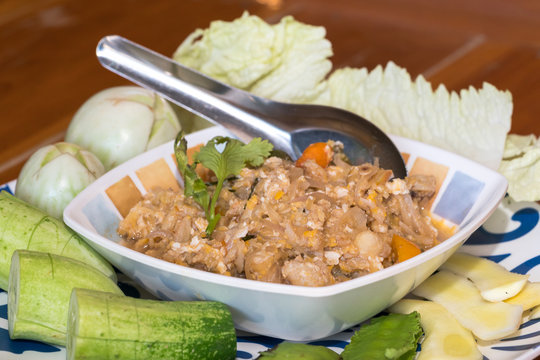 Thai style crab stew in coconut milk with fresh vegetable is one of a delicious Thai food, on wooden background
