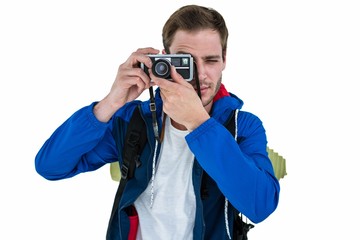 Fototapeta premium Backpacker hipster taking pictures with a retro camera