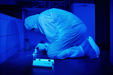Criminologist collecting DNA from unvisible stains