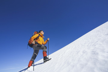 Winter hiking in the mountains with a backpack.