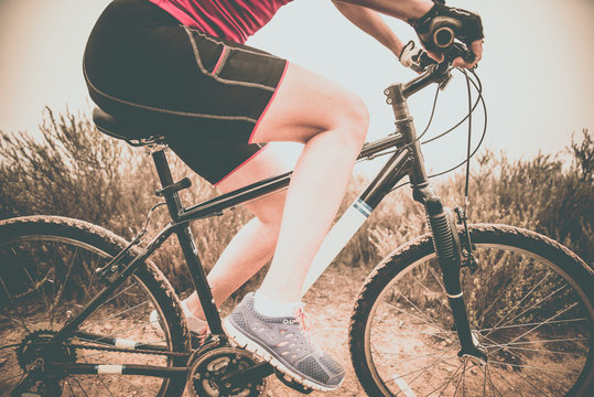 Focused woman riding on her bicycle. Downhill and mountain bike