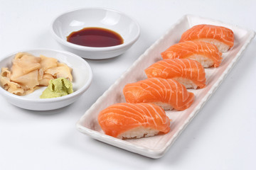Japanese food - salmon sushi served with side dish.