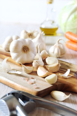Fototapeta na wymiar Garlic, carrots, cabbage and olive oil