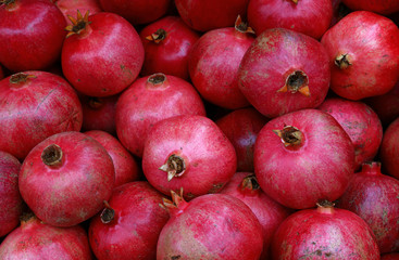 Fresh red ripe pomegranates at retail display