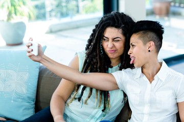 Lesbian couple taking a selfie on phone
