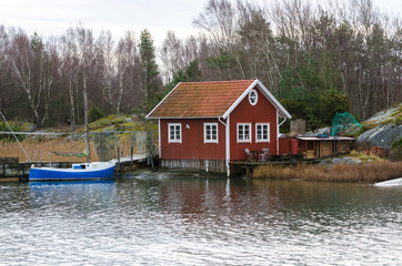 Fototapeta na wymiar fishermans boathouse and boat with pier