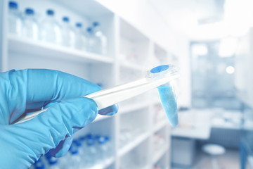 Scientific sample, hand in glove, laboratory