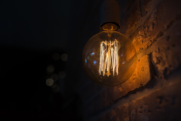 Light bulbs lamps on dark red brick background