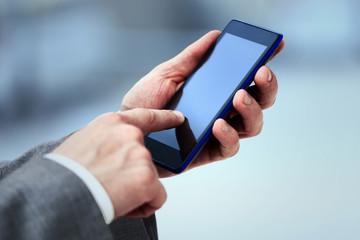 Close up of women's hands holding cell telephone with blank copy space scree for your advertising text message or promotional content, hipster girl watching video on mobile phone during coffee break