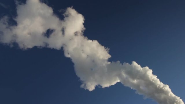 smoke and vapor across blue sky 
