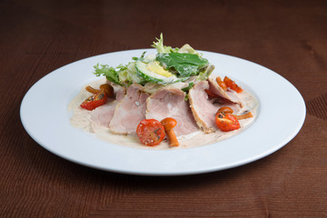 Boiled eggs with smoked ham and vegetables