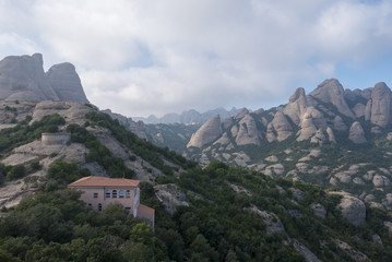 Fototapeta na wymiar Tall mountain near the monastery of Santa Maria de Montserrat in