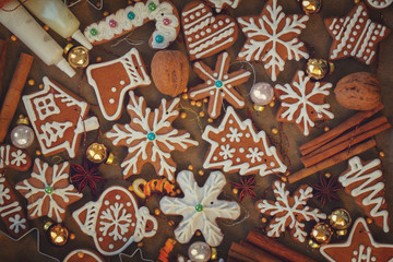 christmas gingerbread cookies with christmas decorations on wood - christmas food background, retro toned