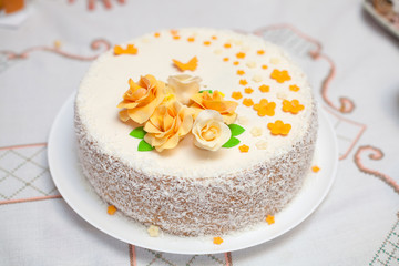 Obraz na płótnie Canvas White mastic cake decorated with flowers, closeup