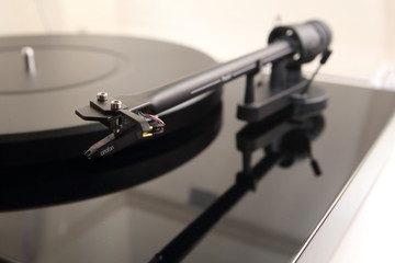 Fototapeta na wymiar Tone arm of a modern high quality turntable record player for vinyl analogue music in shallow focus.