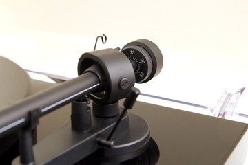 Tracking force adjustment wheel on a vinyl turntable record player
