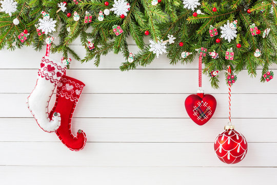 Christmas background. Christmas fir tree, Christmas socks and decon white wooden board background. Top view, copy space 