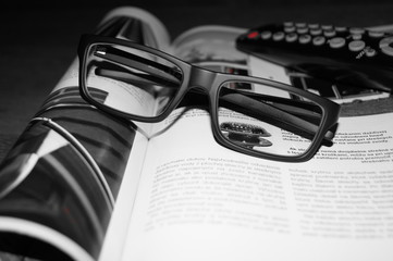 Glasses, magazine, TV Remote Control means relax 