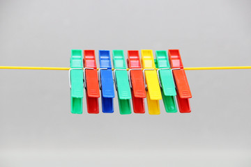 colored plastic clothespins hanging on the rope.