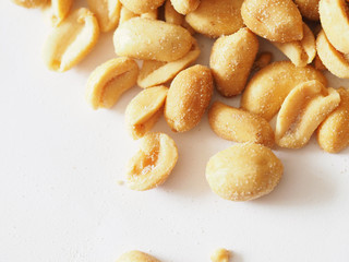salted roasted peanuts on a white background