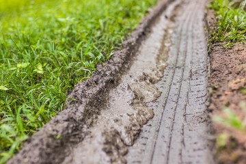 The Tire marks on the muddy ground