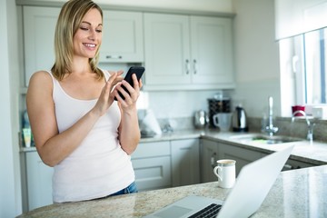 Pretty blonde woman looking at smartphone